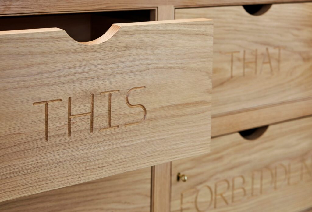 Custom oak larder unit inside drawer beneath worktop